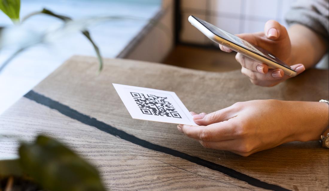 Person scannt QR Code