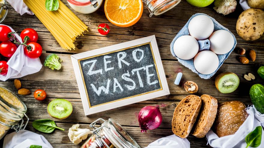 Tafel mit der Aufschrift "Zero Waste" inmitten verschiedener Lebensmittel
