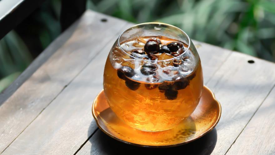 Glas mit Cascara-Tee auf einem Tisch im Freien